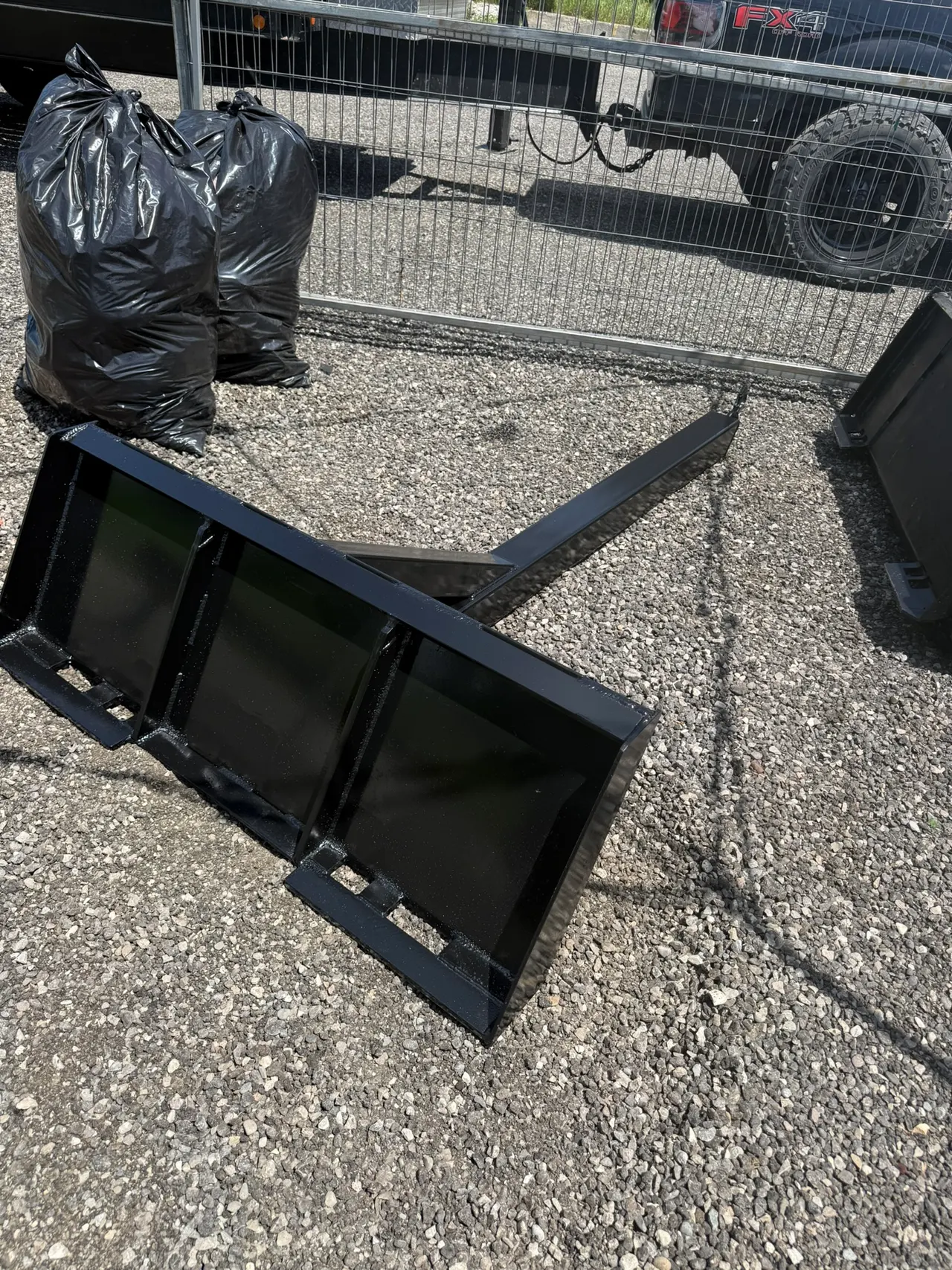 Steel equipment attachment photographed outside the workshop