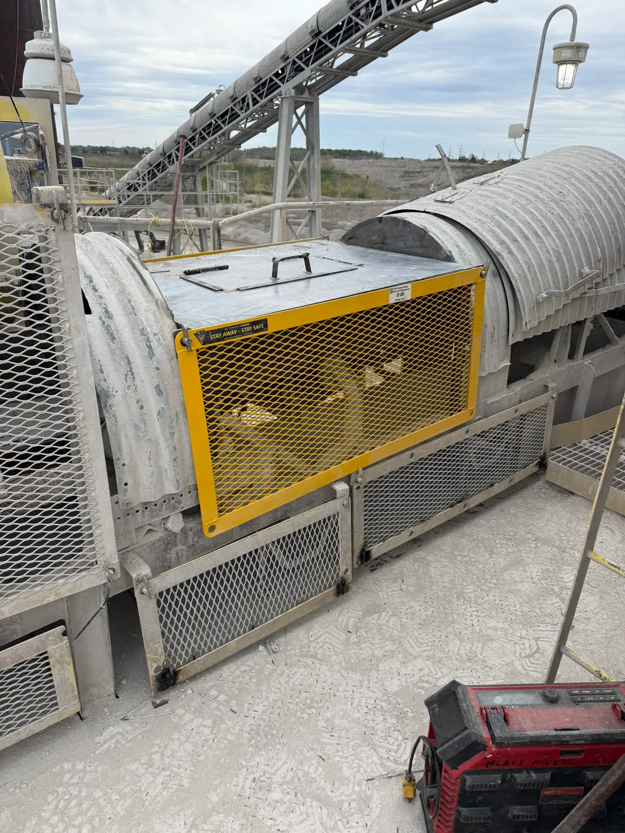 Yellow industrial equipment and surrounding steelwork at a plant